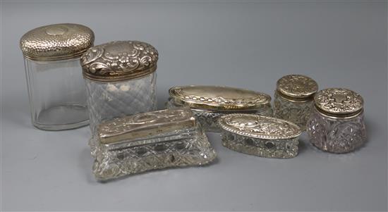 Seven assorted silver mounted toilet jars.